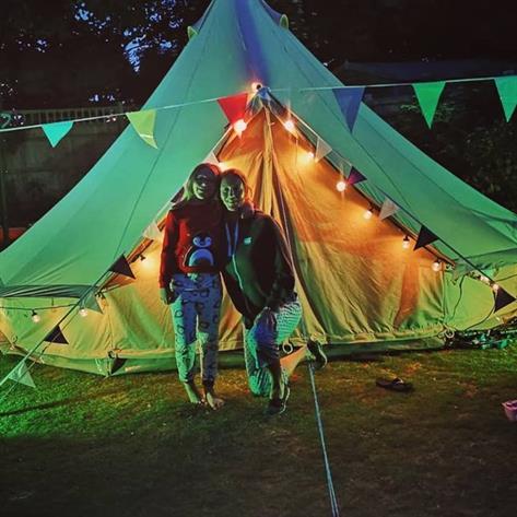 Mum and child outside a bell tent